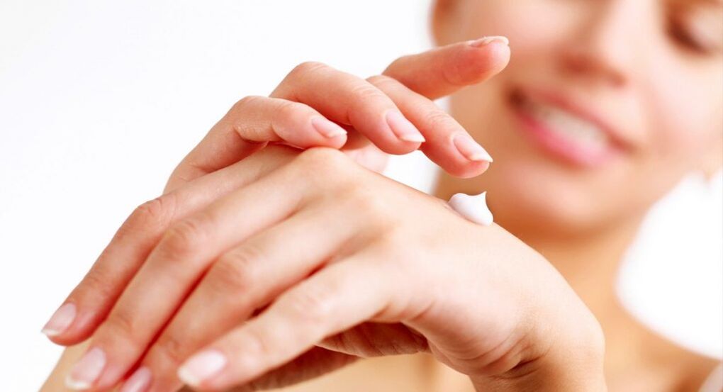 applying hand cream to rejuvenate the skin